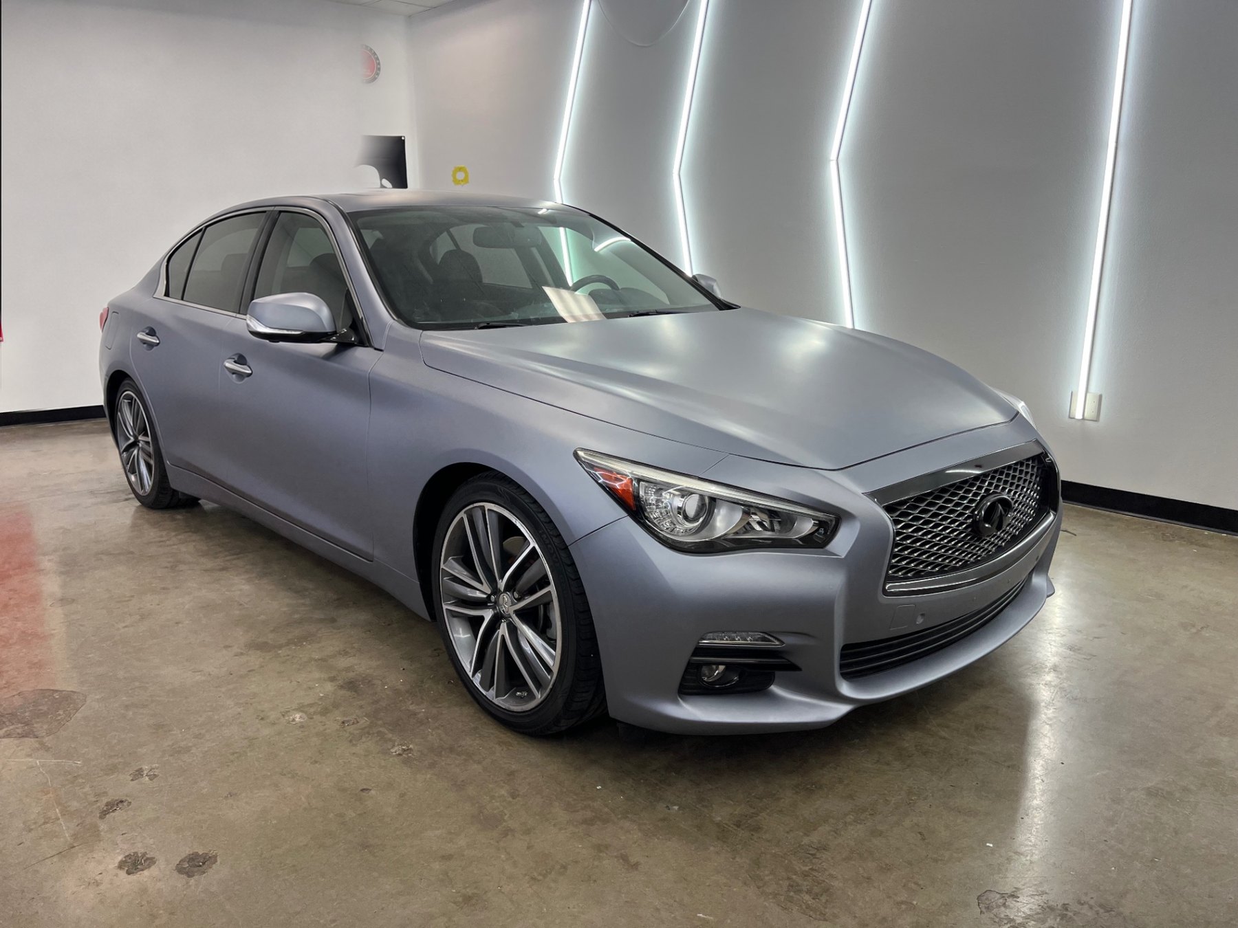 Completed matte gray vinyl wrap on an Infiniti sedan