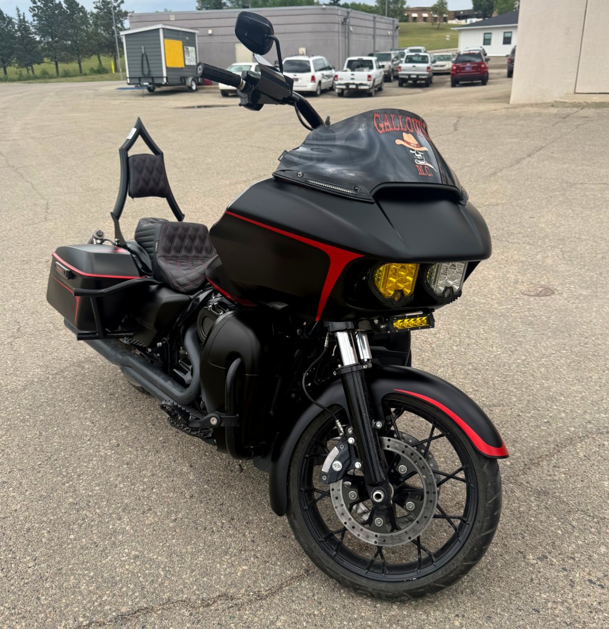 Matte black wrapped Harley-Davidson Road Glide with red accent lines