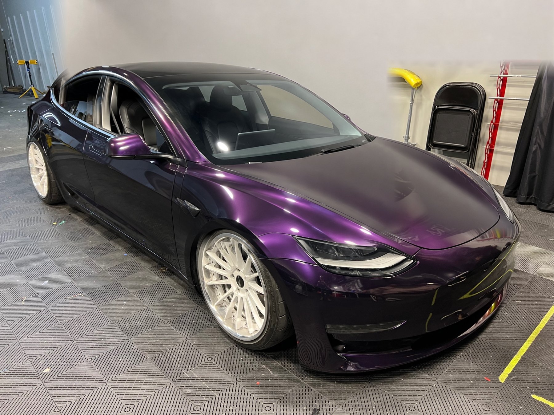 Completed deep purple color-shift vinyl wrap on a Tesla